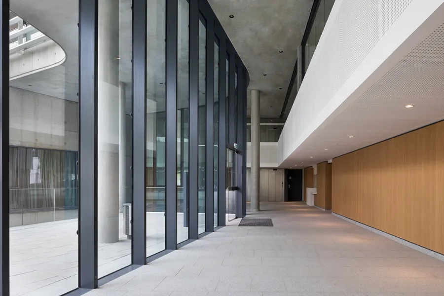Le plafond du hall principal, façon faux plafond en béton gris autoplaçant, « suspendu » à la dalle porteuse des étages supérieurs. 