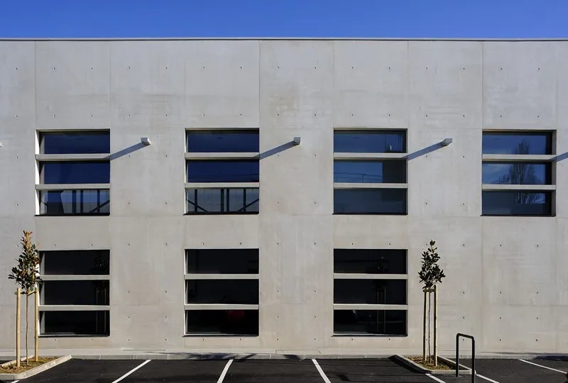 Façade sud, des brise- soleil en béton préfabriqués protègent les ouvertures du rayonnement tout en participant à leur redécoupage. Façade sud, des brise- soleil en béton préfabriqués protègent les ouvertures du rayonnement tout en participant à leur redécoupage.