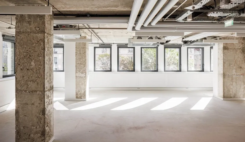 Les plateaux de coworking sont reliés au passé du bâtiment par la mise à nu des poteaux et plafond béton.