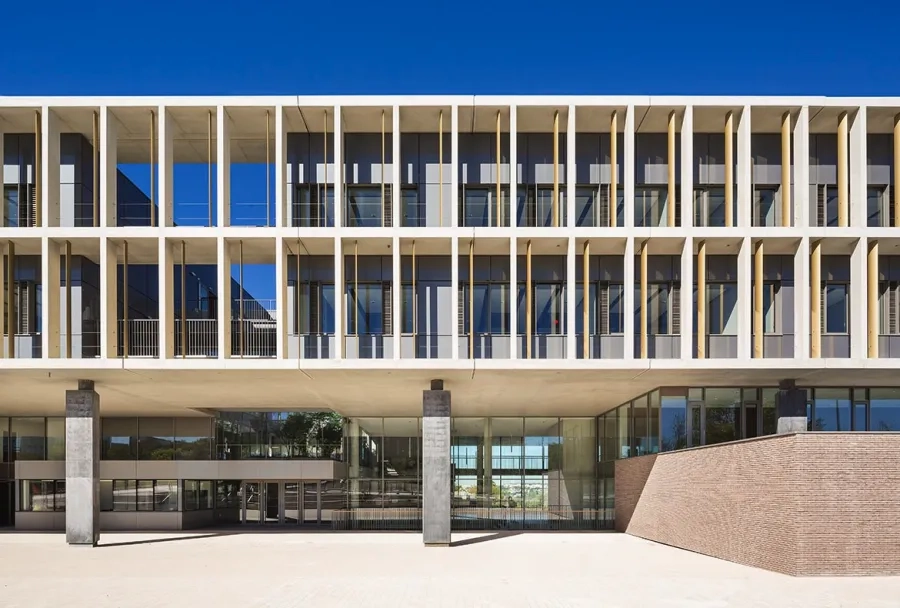 entrée en façade est, tout en transparence. Par leur disposition en retrait du plancher, les poteaux triangulaires en béton noir accentuent l’e et de soulèvement des étages. entrée en façade est, tout en transparence. Par leur disposition en retrait du plancher, les poteaux triangulaires en béton noir accentuent l’e et de soulèvement des étages.